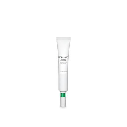 Slim white tube of calming spot cream with green accent cap for targeted skin soothing care