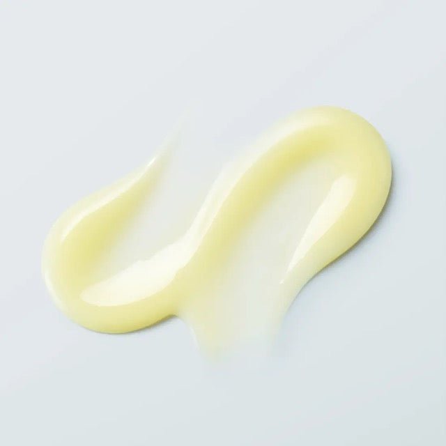 Pale yellow glossy ampoule texture swatch showing a smooth lightweight gel cream on a light blue background