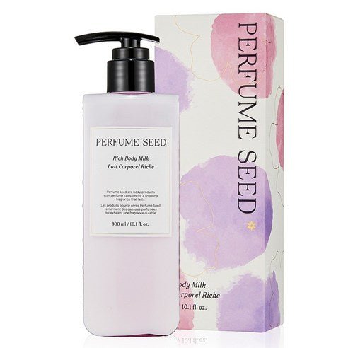 Tall pale pink pump bottle of rich body milk next to decorative box with soft purple and pink watercolor accents