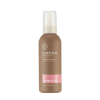 Matte brown bottle of essential hair oil serum with white pump cap and pink label strip on white background